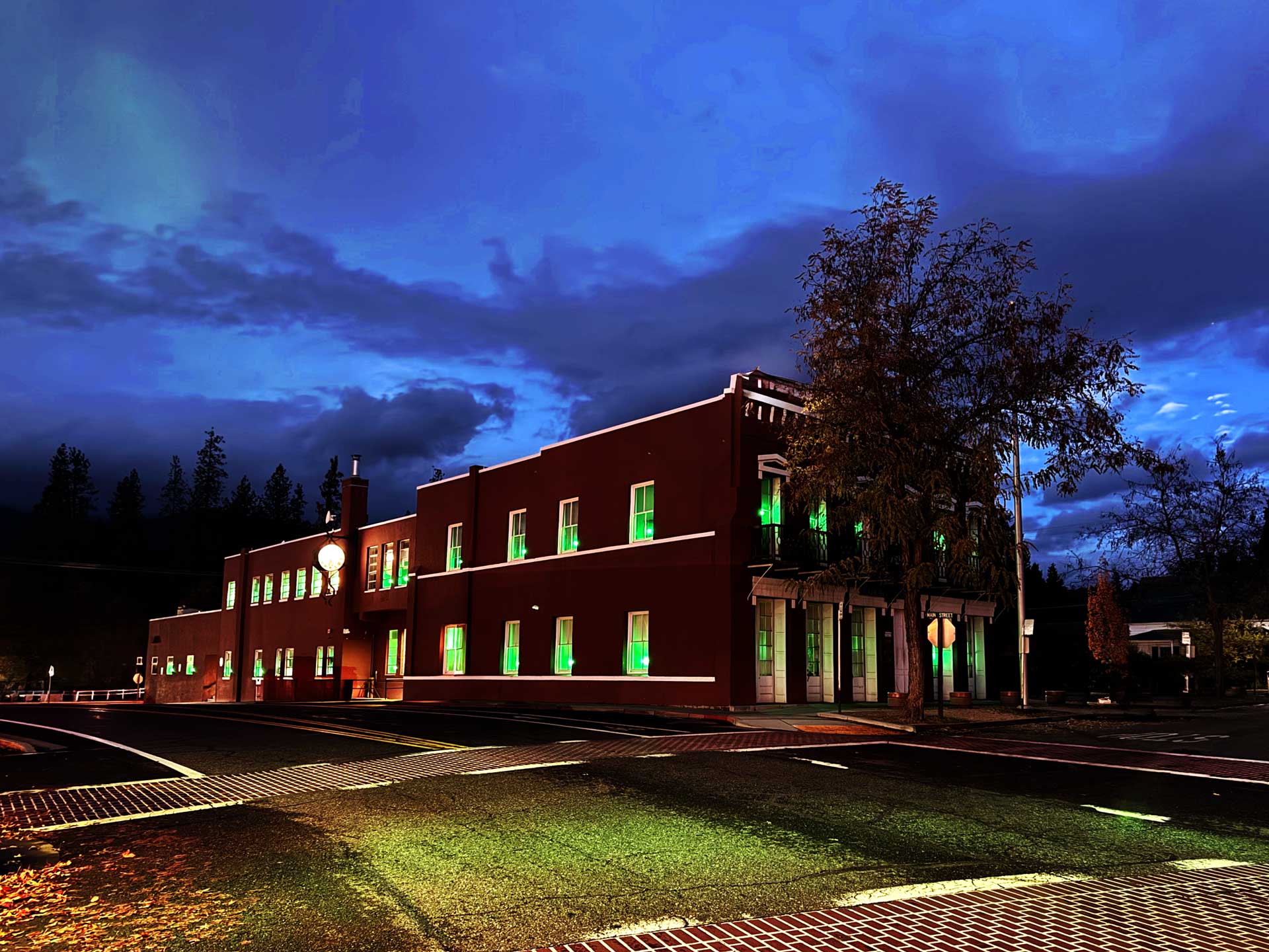 The windows of the Trinity County Courthouse are light up green. 